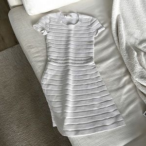 Michael Kors form fitting dress with smell cut out mid drift